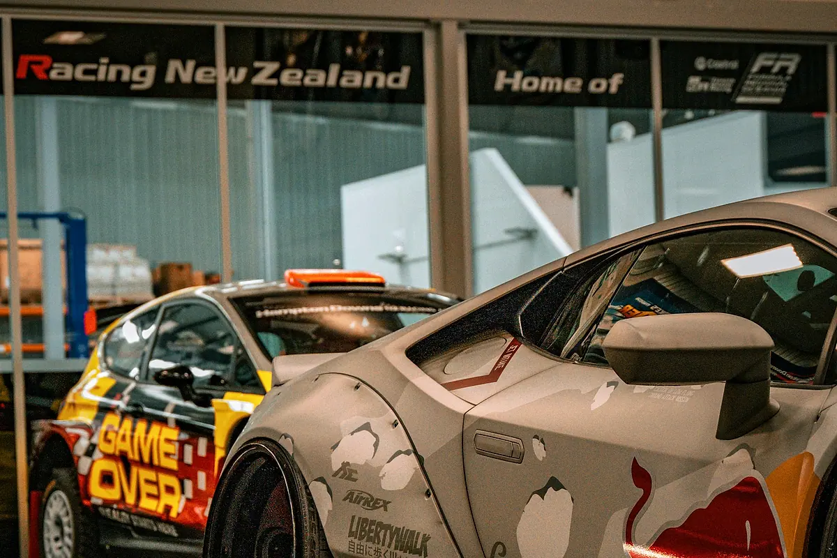 Cars with widebody arches inside a workshop hall